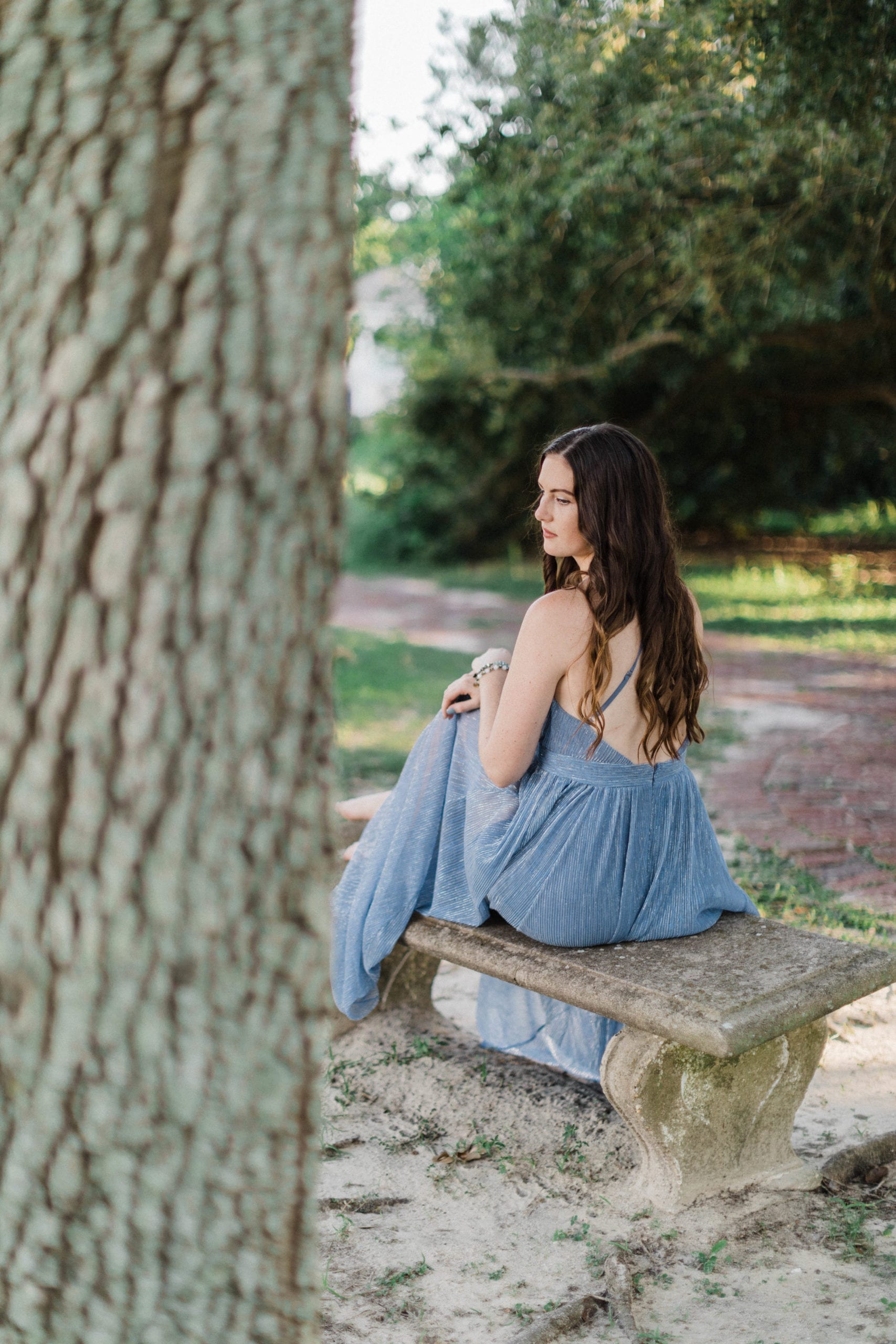 portrait of soon to be bride, sitting on cement bench