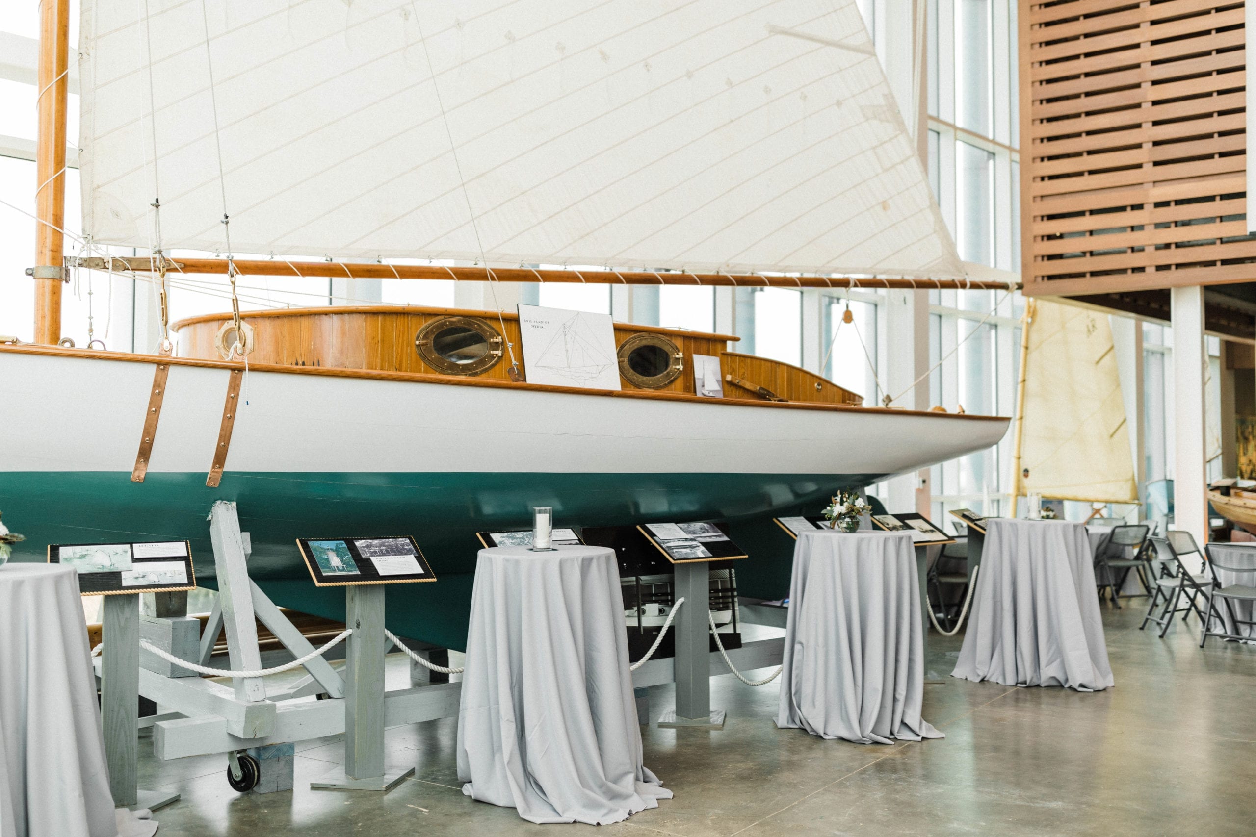 Tables next to sailboat in Maritime and Seafood Industry Museum wedding reception