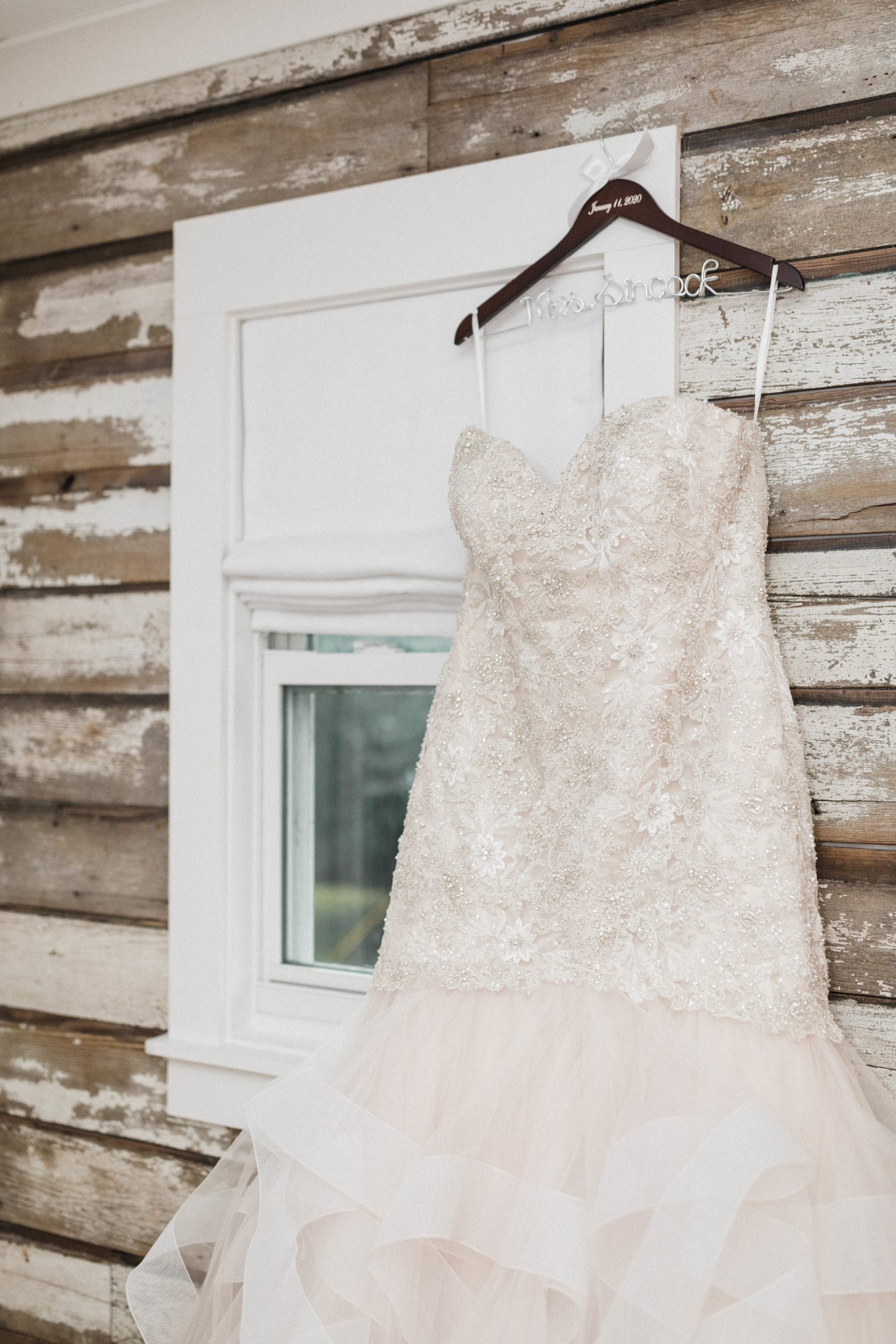 Wedding Dress on wooden hanger The Roost Ocean Springs Bridal suite