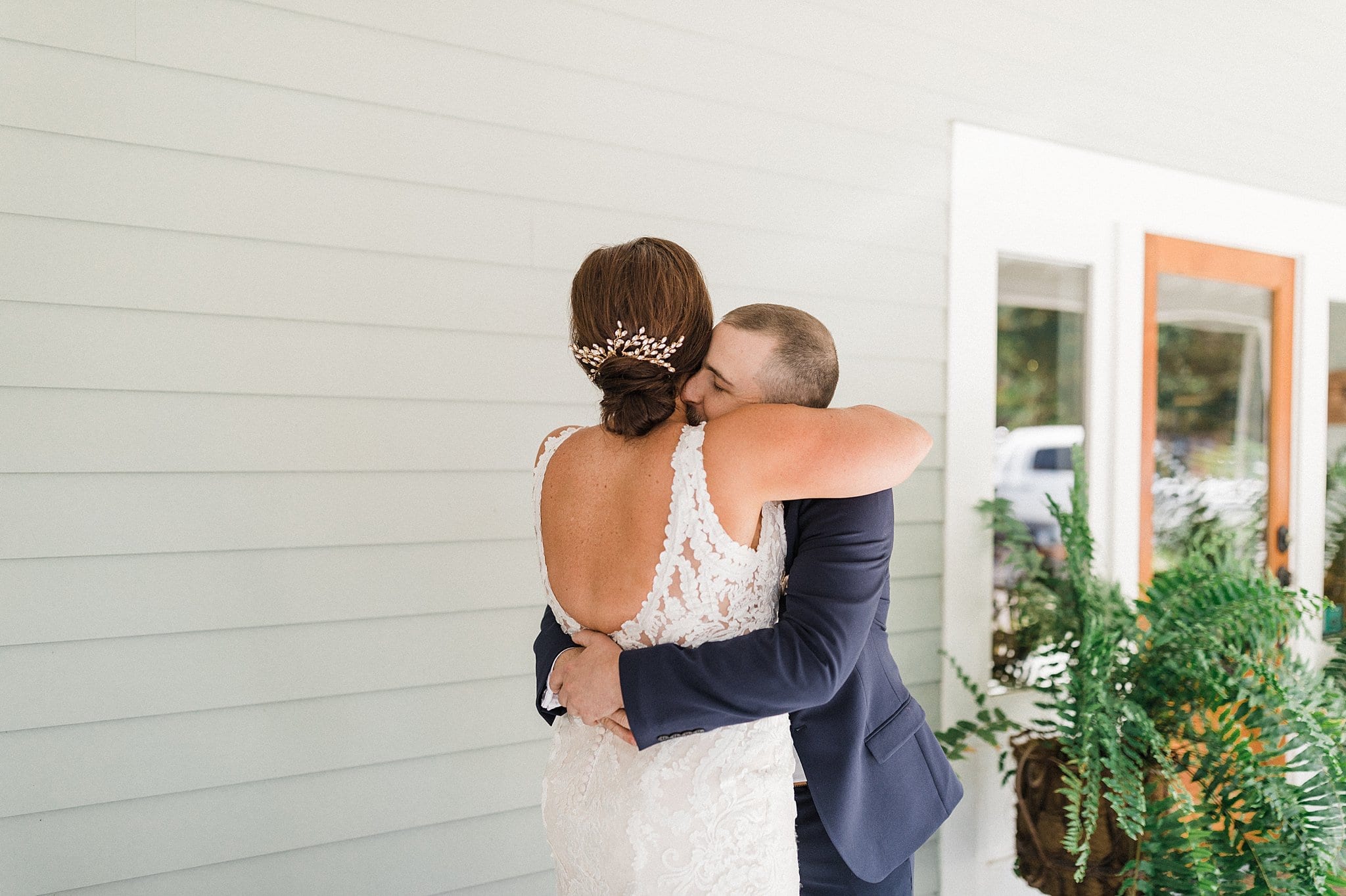 bride and groom hugging on porch