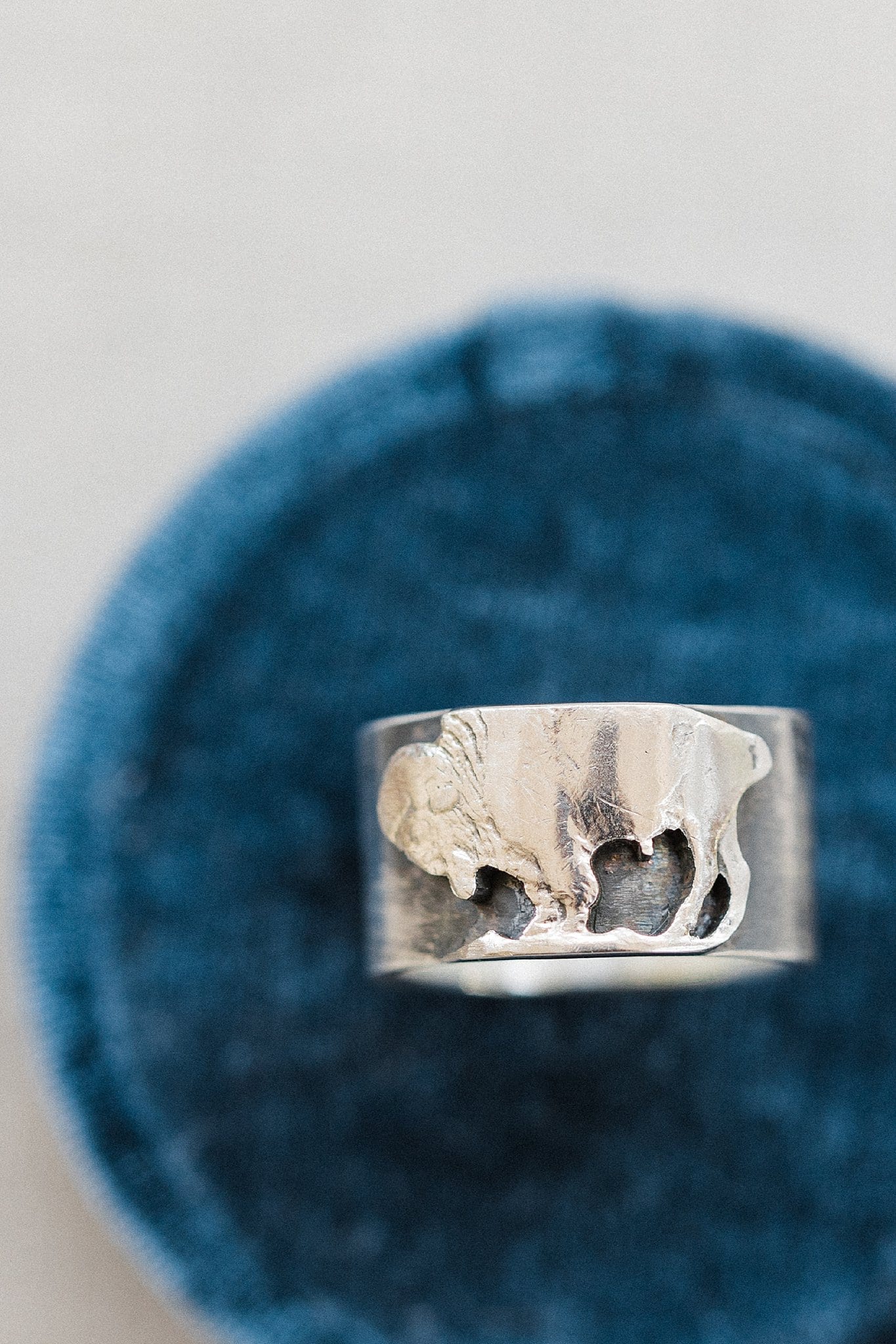 detail image of buffalo on groom's wedding ring