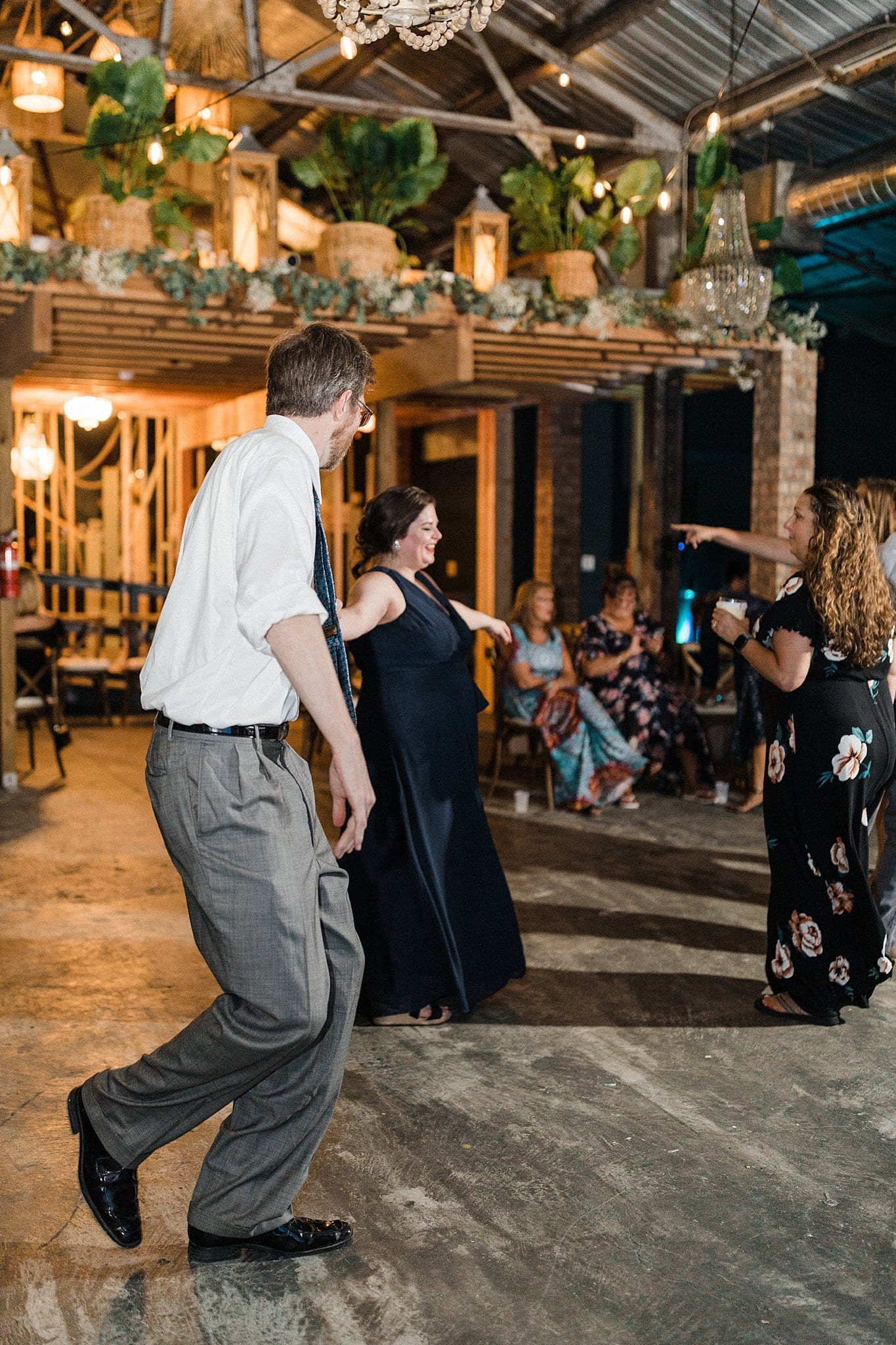 bridesmaid and husband dancing at wedding reception