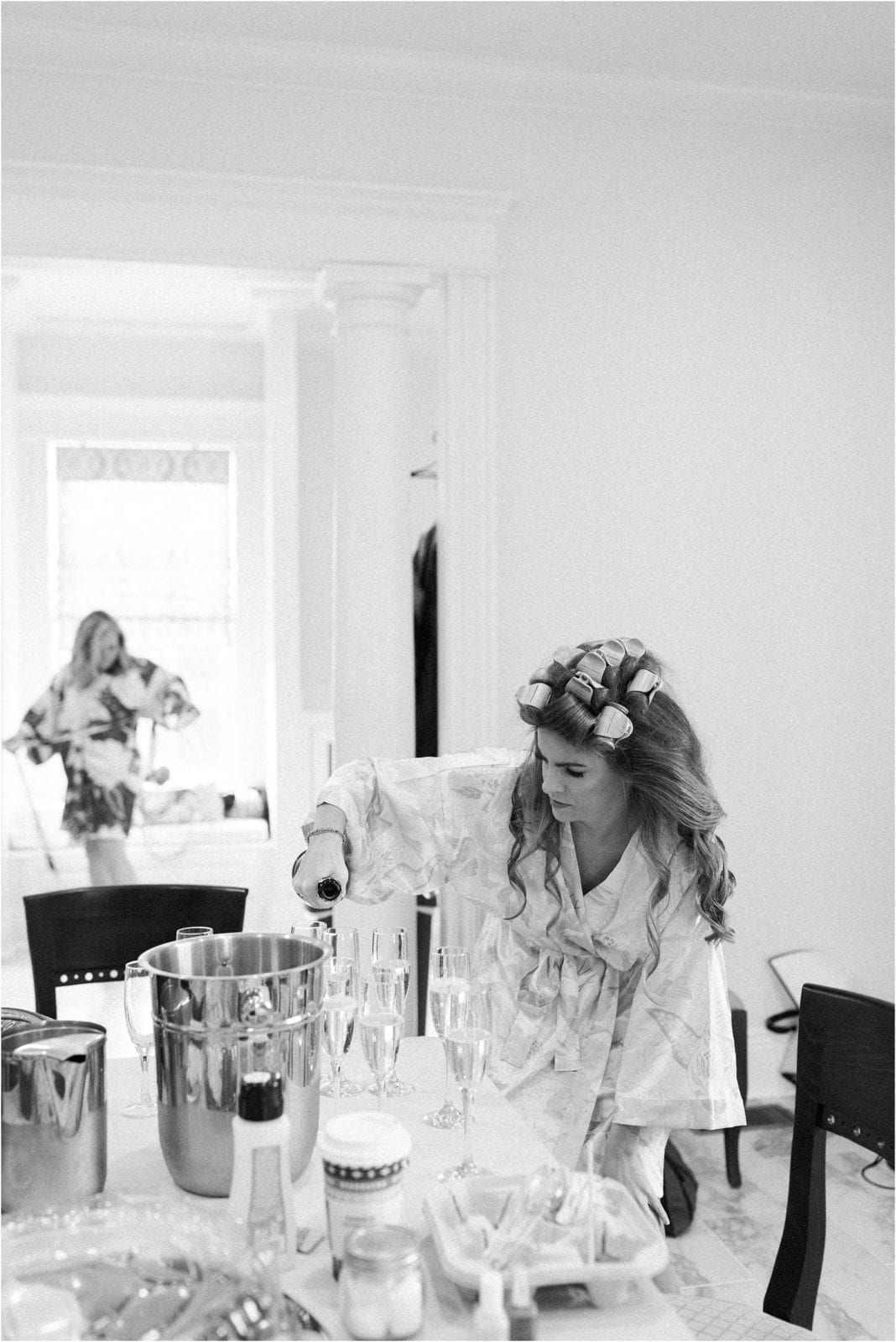 bride pours mimosas for her bridesmaids