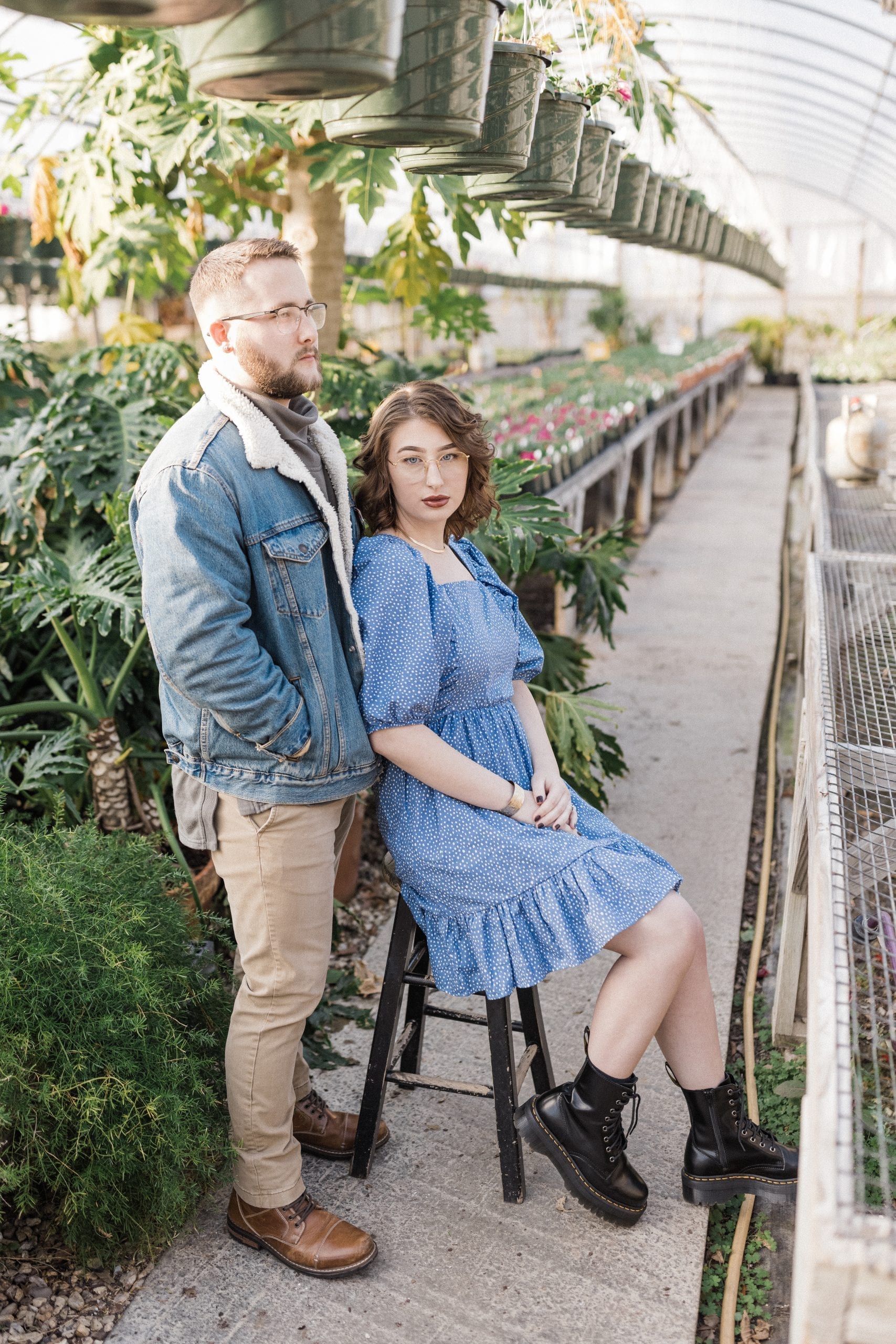 serious portrait of engaged couple in greenhouse