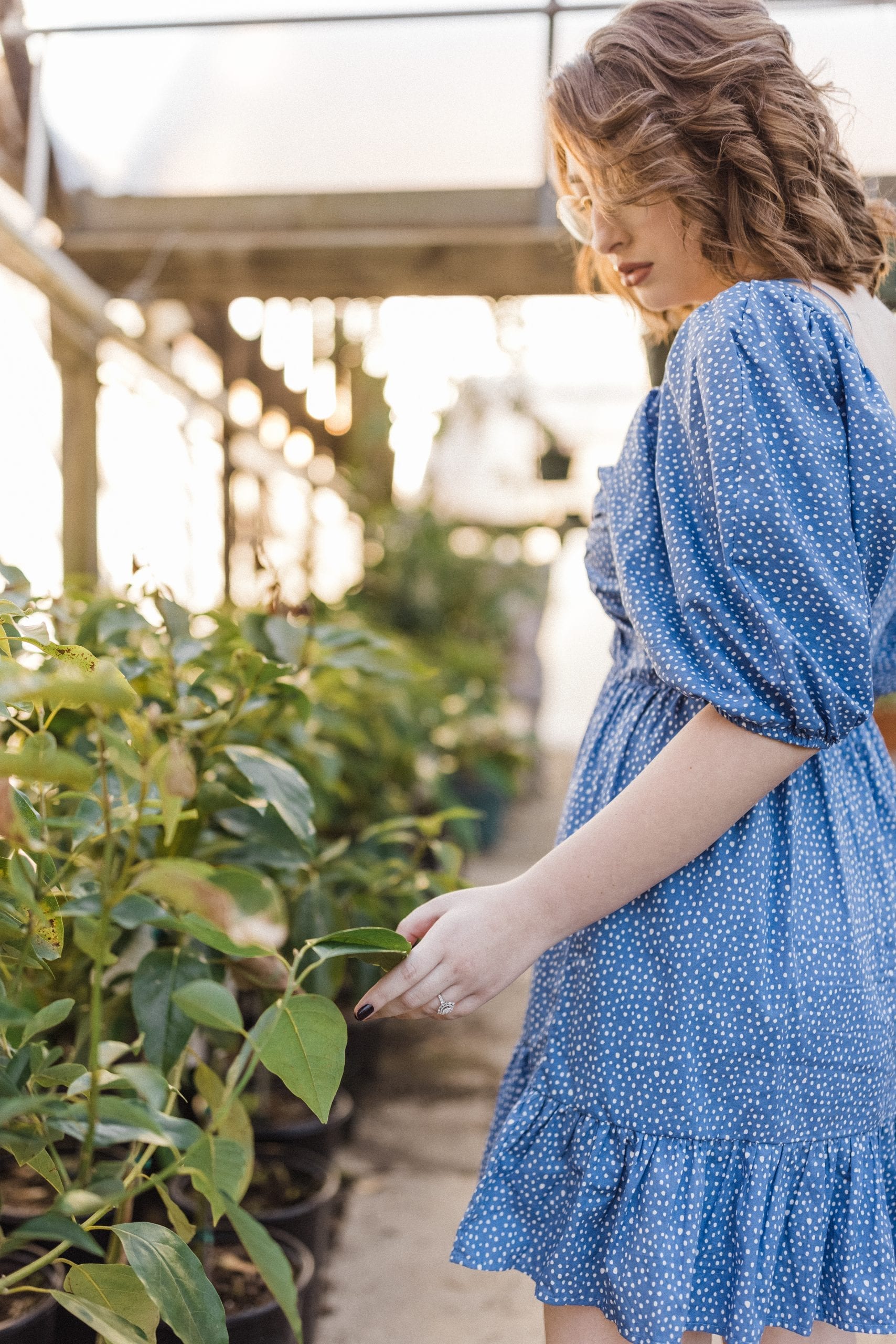 future bride explores plants in greenhouse
