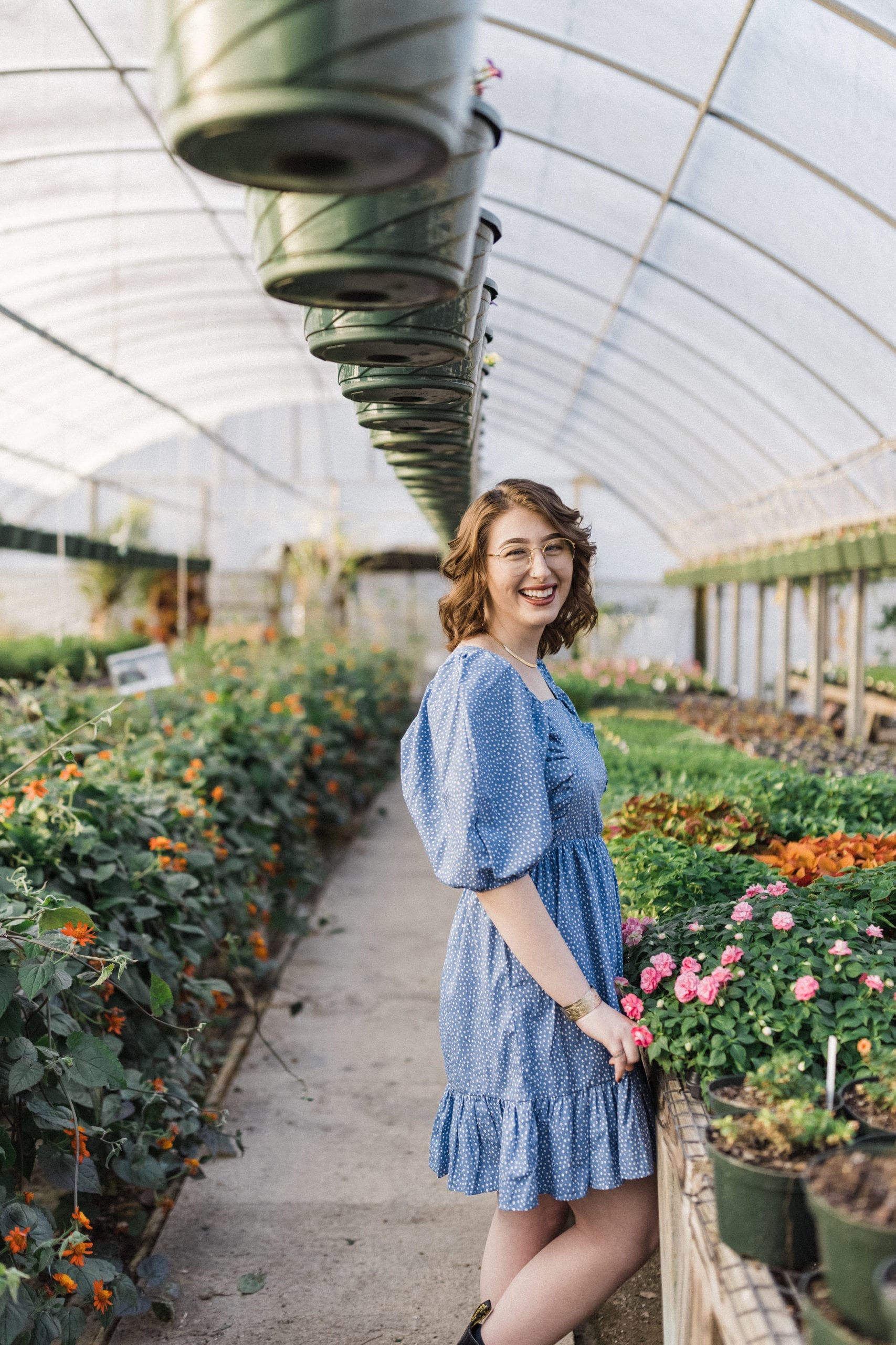 smiling bride to be inside greenhouse
