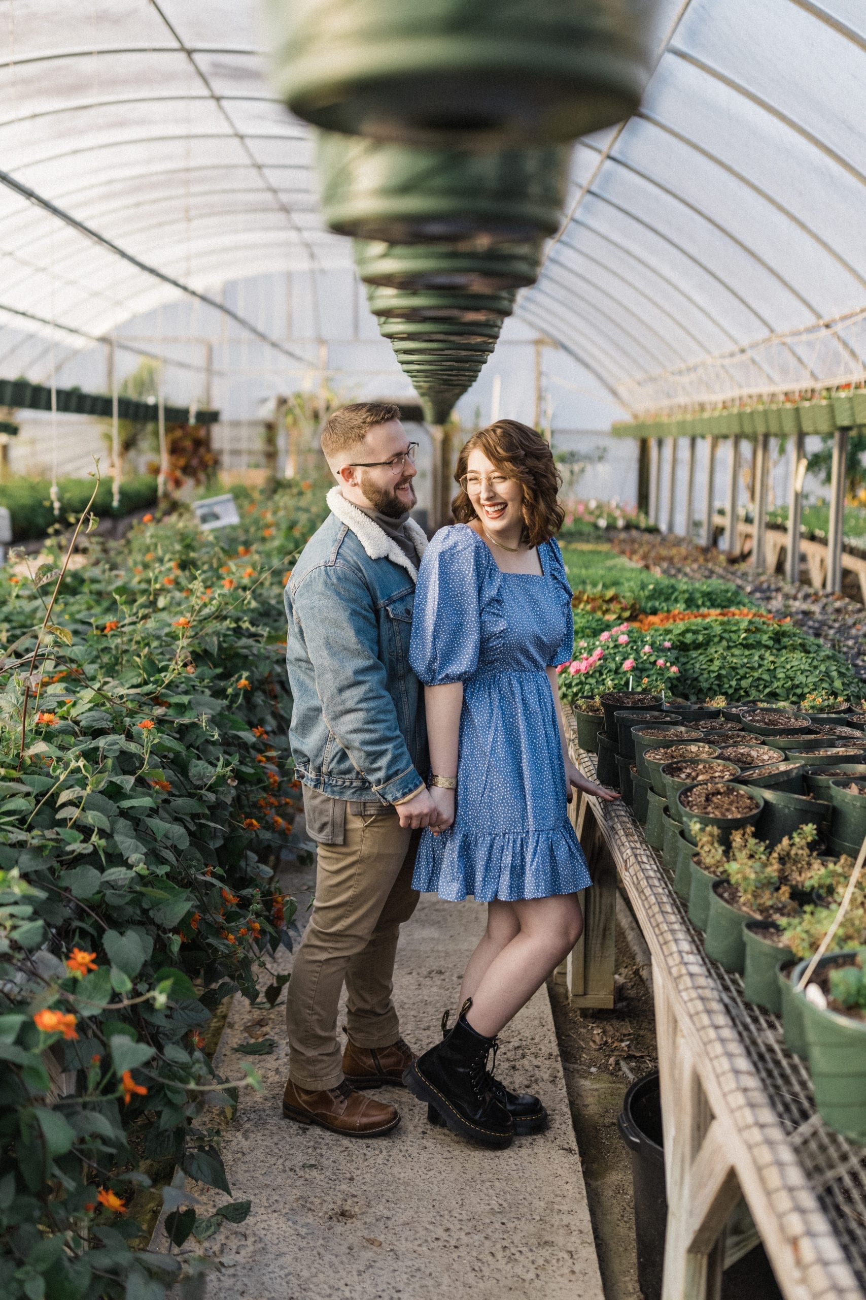 future bride laughs at fiance in greenhouse